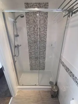 a shower with a glass door in a bathroom at The Kerswell Hotel Sea Front in Morecambe