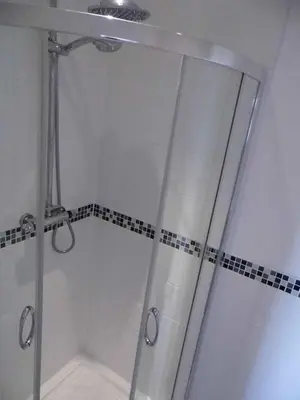 a shower with a glass door in a bathroom at The Kerswell Hotel Sea Front in Morecambe