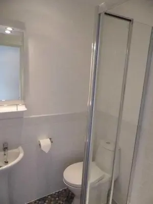 a bathroom with a toilet and a sink and a shower at The Kerswell Hotel Sea Front in Morecambe