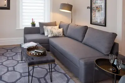 a living room with a blue couch and a table at Blackbird Luxury Apartments Room 3 in Blackpool