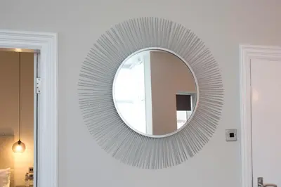 a circular mirror on a wall in a room at Blackbird Luxury Apartments Room 3 in Blackpool