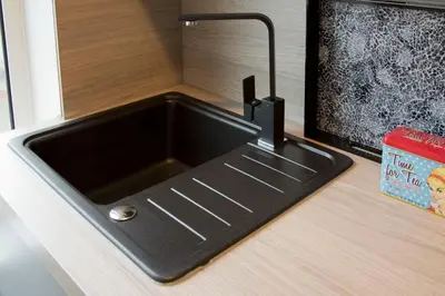 a black kitchen sink sitting on top of a counter at Blackbird Luxury Apartments Room 2 in Blackpool