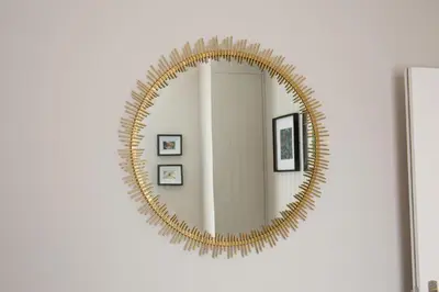 a gold oval mirror on a white wall at Blackbird Luxury Apartments Room 2 in Blackpool