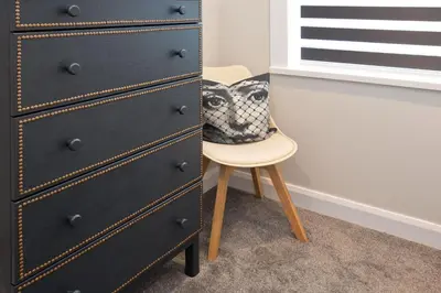 a chair next to a dresser with a pillow on it at Blackbird Luxury Apartments Room 1 in Blackpool