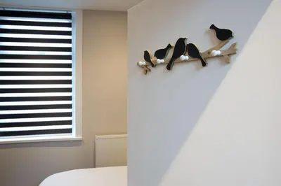 a room with a shelf with birds on the wall at Blackbird Luxury Apartments Room 1 in Blackpool