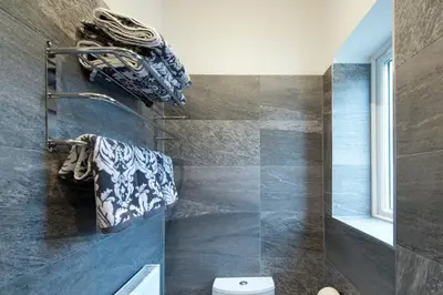 a bathroom with a toilet and some towels on a wall at Blackbird Luxury Apartments Room 1 in Blackpool