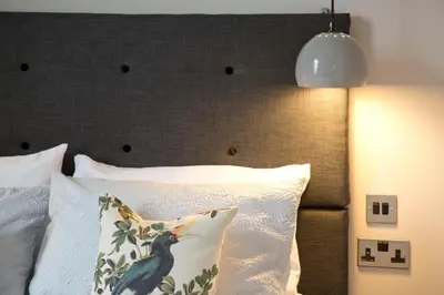 a bedroom with a bed with a large headboard at Blackbird Luxury Apartments Room 1 in Blackpool