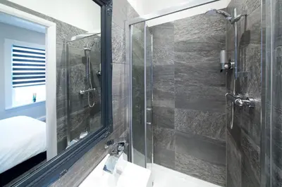a bathroom with a shower and a mirror at Blackbird Luxury Apartments Room 1 in Blackpool