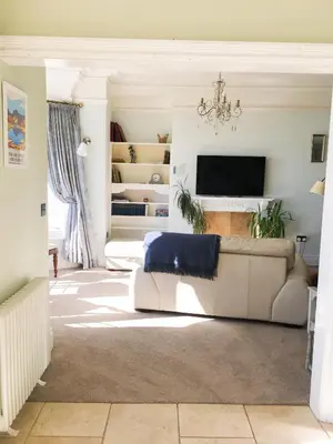 a living room with a couch and a tv at East Bank Apartment in Grange Over Sands