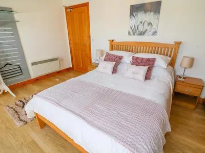 a bedroom with a large white bed with pillows at Shorefields Two in Morecambe
