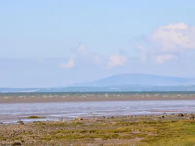 a view of the ocean with a mountain in the background at Shorefields Two in Morecambe