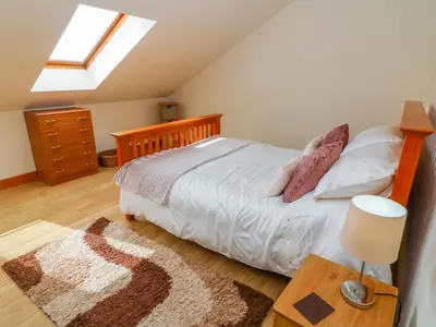 a bedroom with a bed and a skylight at Shorefields Two in Morecambe