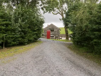 a gravel road leading to a red phone booth at Oak Lodge in Ulverston