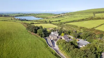 an aerial view of a house in a green field at Oak Lodge in Ulverston