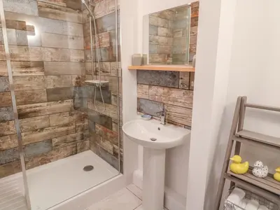 a bathroom with a sink and a shower at Shady Bowers in Carnforth