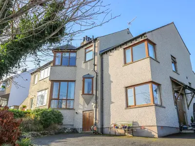 a large brick house with a lot of windows at Langtree in Carnforth