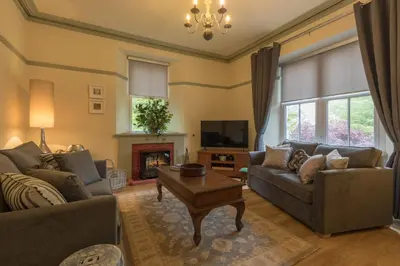 a living room with two couches and a fireplace at Woodhaven - Luxury 4 bedroom rural retreat with hot tub near to Lake District in Grange Over Sands