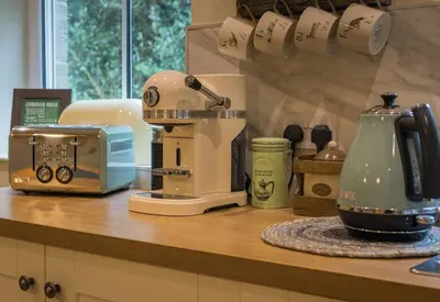 a kitchen counter with a mixer and a toaster at Woodhaven - Luxury 4 bedroom rural retreat with hot tub near to Lake District in Grange Over Sands
