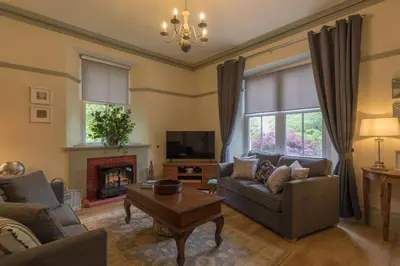 a living room with a couch and a fireplace at Woodhaven - Luxury 4 bedroom rural retreat with hot tub near to Lake District in Grange Over Sands