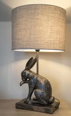 a bronze statue of a rabbit on a table with a lamp at Woodhaven - Luxury 4 bedroom rural retreat with hot tub near to Lake District in Grange Over Sands