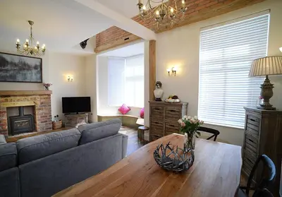 a living room with a couch and a table at Pippin Lodge Lytham in Lytham St Annes