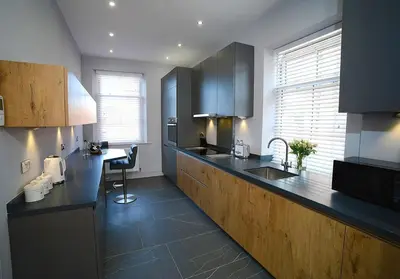 a kitchen with a counter and a sink in it at Pippin Lodge Lytham in Lytham St Annes