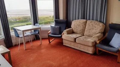 a living room with a couch and two chairs and a table at The Kathrene in Fleetwood