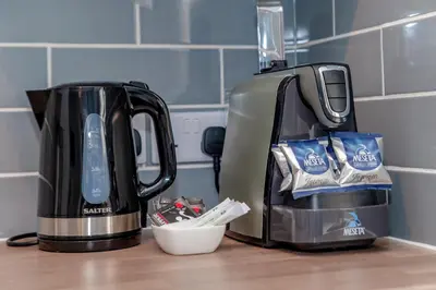 two coffee makers sitting on a kitchen counter at Design Suites Lytham in Lytham St Annes