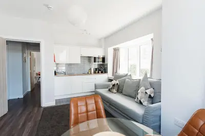 a living room with a couch and a table at Design Suites Lytham in Lytham St Annes