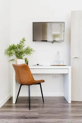 a chair sitting in front of a white desk at Design Suites Lytham in Lytham St Annes