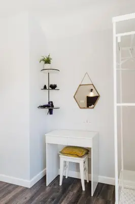 a room with a white desk and a shelf at Design Suites Lytham in Lytham St Annes