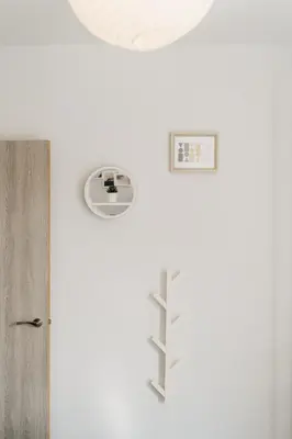 a room with a door and a clock on the wall at Design Suites Lytham in Lytham St Annes