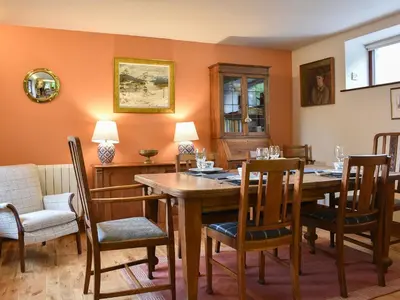 a dining room with a wooden table and chairs at Yew Tree Farm in High Newton