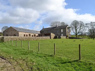 a large house in a field with a fence at Lakeland View in Scotforth