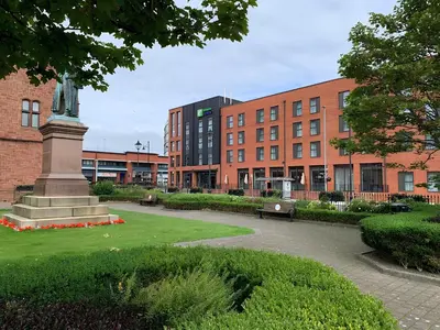 a statue in a park in front of a building at Holiday Inn Express - Barrow-in-Furness & South Lakes by IHG in Barrow in Furness