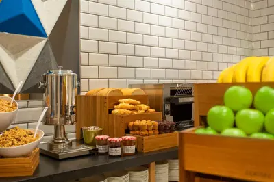 a counter with green apples and pastries on it at Holiday Inn Express - Barrow-in-Furness & South Lakes by IHG in Barrow in Furness