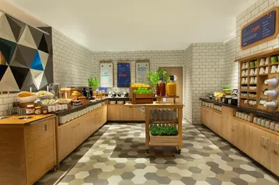 a restaurant with a buffet line with food at Holiday Inn Express - Barrow-in-Furness & South Lakes by IHG in Barrow in Furness