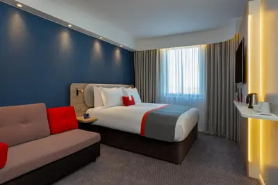 a hotel room with a bed and a couch at Holiday Inn Express - Barrow-in-Furness & South Lakes by IHG in Barrow in Furness