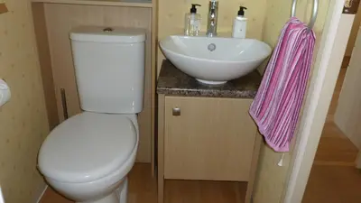 a bathroom with a white toilet and a sink at 28 Borwick Lakes in Carnforth