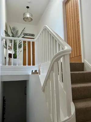 a white staircase in a home with a potted plant at The Place - Lytham in Lytham St Annes