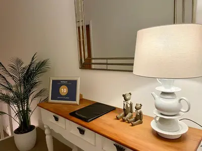 a table with a lamp and two figurines on it at The Place - Lytham in Lytham St Annes