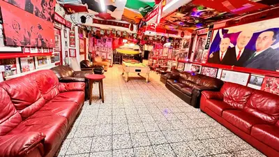 a room with red leather couches in a bar at Castle Lodge Guest House 86-88 Sheil Rd L6 3AF in Liverpool