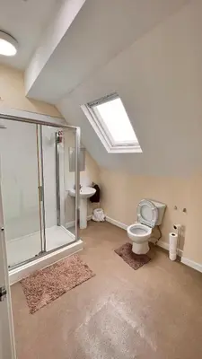 a bathroom with a shower and a toilet and a sink at Castle Lodge Guest House 86-88 Sheil Rd L6 3AF in Liverpool