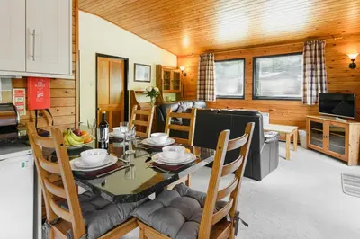 a kitchen and dining room with a table and chairs at Woodlands Hotel & Pine Lodges in Grange Over Sands