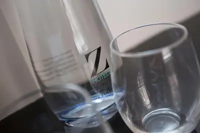 two empty wine glasses sitting on a table at The Z Hotel Liverpool in Liverpool