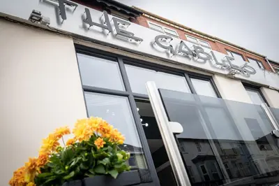 a store front with a sign and flowers on the door at The Gables Hotel by Cherish Lewis Blackpool in Blackpool