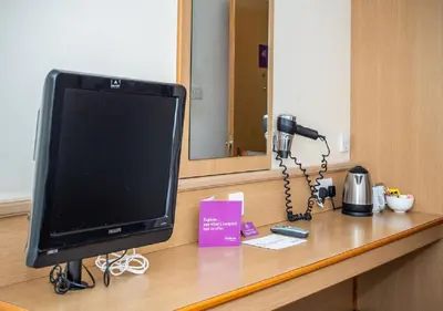 a television sitting on a counter in a room at Stables Inn, Aintree in Liverpool