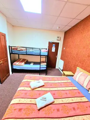 a room with two bunk beds with towels on them at The Albany hotel in Blackpool