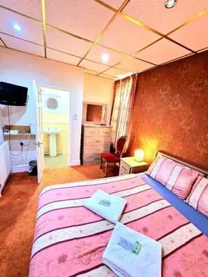 a hotel room with two beds and a television at The Albany hotel in Blackpool