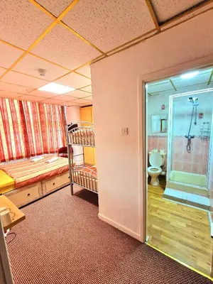 a room with a bathroom with a shower and a toilet at The Albany hotel in Blackpool